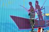 Artist Jonathan Judge, the director of media and campaigns for Rise Above Colorado, puts the finishing touches on a new mural on the south side of Ronning’s in downtown Baudette on Monday, May 23, 2022.