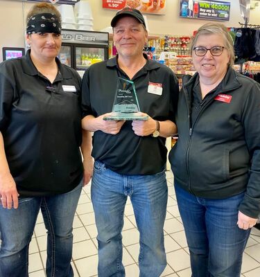 Jen Gardner, Joe Palm, and Store Manager Janice Kobberman proudly show their store's recent award. Photo by Shawna Wendler