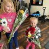 Remi and Vada, daughters of Kristi Pierce and Shane Burk, enjoyed the beautiful bouquets during Rotary Rose pick-up. Photo submitted by Ann Ellis