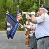 Jeff Bauers with the Baudette Ceremonial Squad plays taps Monday, May 30, 2022, at the Wabanica Cemetery north of Baudette, Minn., to honor American military veterans.